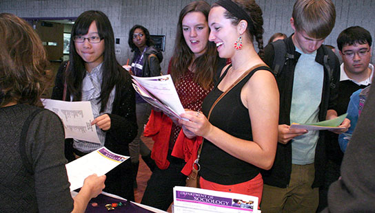 Students at majors fair talking with staff